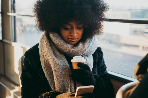 Beautiful girl with afro haircut portraits in the public transpo — Stock Photo, Image