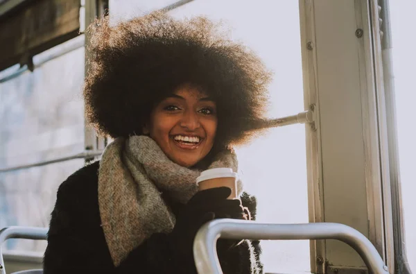 Beautiful girl with afro haircut portraits in the public transpo — Stock Photo, Image