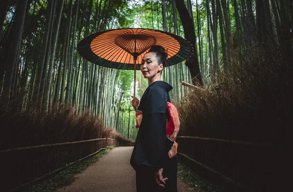 Hermosa japonesa mayor mujer caminando en el bosque de bambú — Foto de Stock