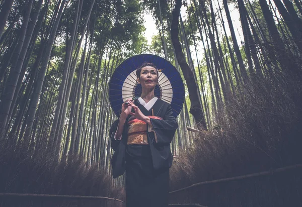 Bela japonesa sênior mulher andando na floresta de bambu — Fotografia de Stock