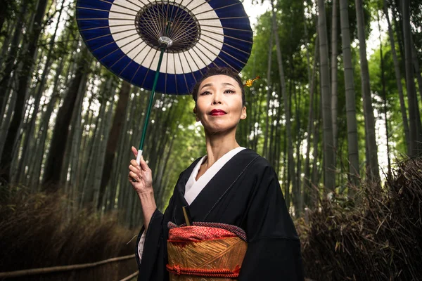 Belle femme japonaise senior marchant dans la forêt de bambous — Photo