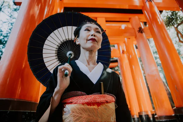 Hermosa japonesa mayor mujer caminando en el fushimi inari shr — Foto de Stock