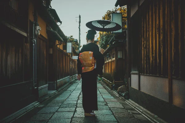 Beautiful japanese senior woman walking in the village. Typical