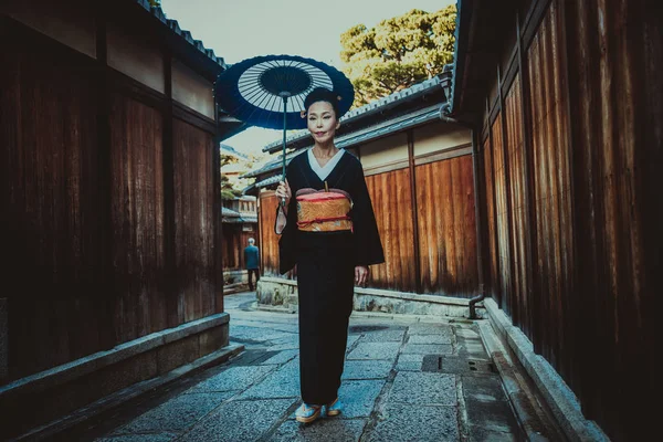 Beautiful japanese senior woman walking in the village. Typical