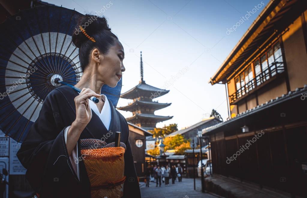 Beautiful japanese senior woman walking in the village. Typical 