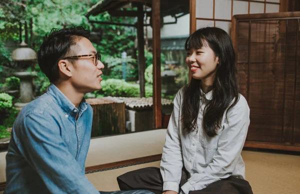 Young japanese couple spending time in their house