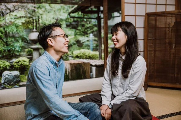 Young japanese couple spending time in their house