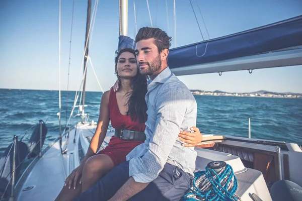 happy couple taking a romantic cruise on the sail boat