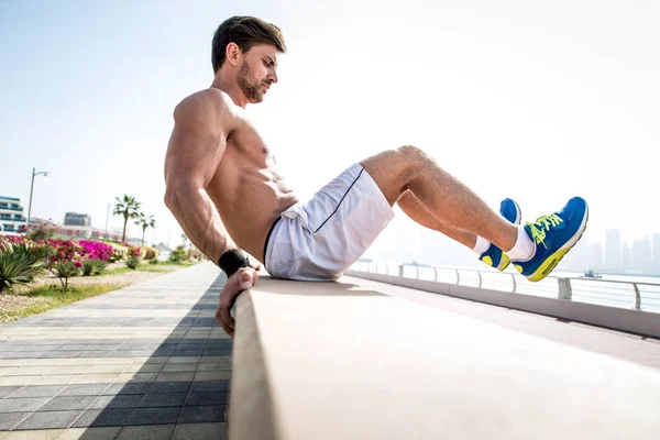 Beautiful man doing work out and different exercises outdoor