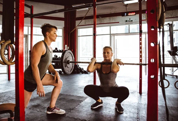 Active people make functional training in the gym