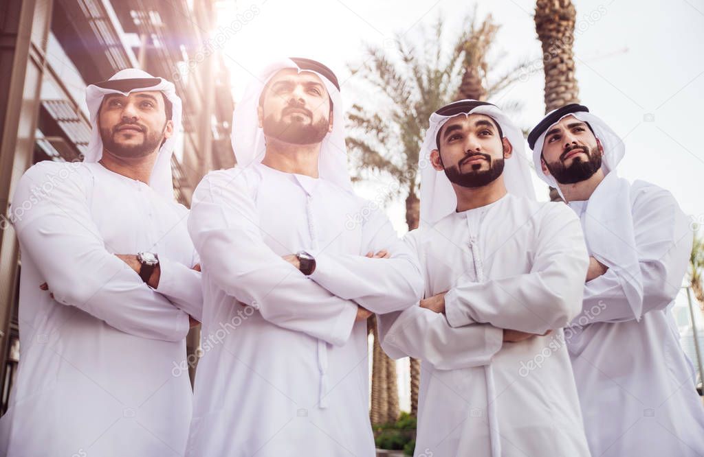 Group of businessmen talking on the street in Dubai