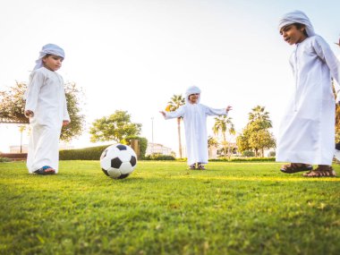 Arabic kids playing at the park in Dubai