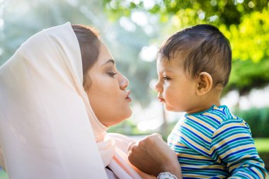 Arap anne ve küçük bebeği dışarıda oynuyorlar.