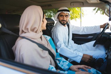 Arabic couple driving in a car