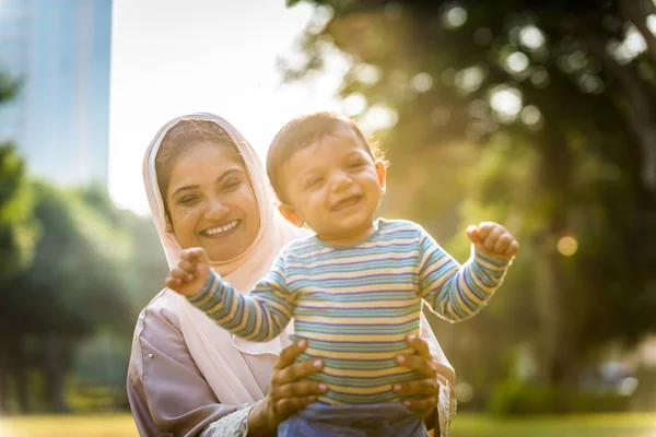 Arabic mom and her little toddler playing outdoors — Stock Photo, Image