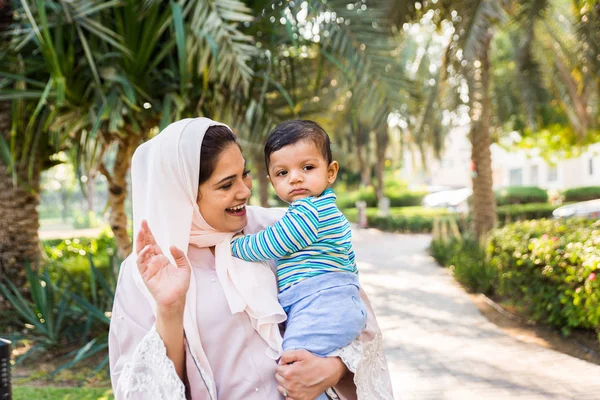 Arap anne ve küçük bebeği dışarıda oynuyorlar.