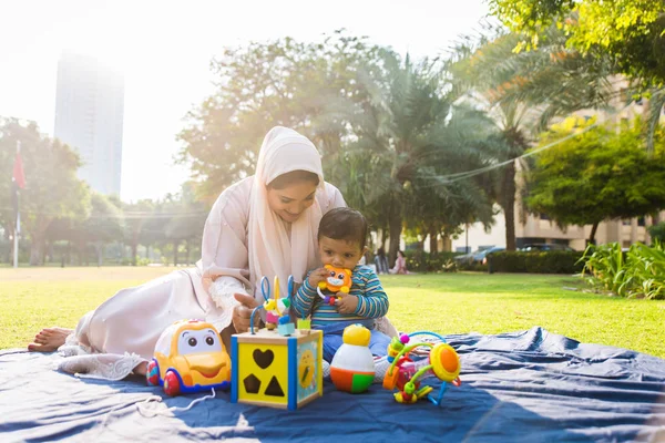 Arabic mom and her little toddler playing outdoors — Stock Photo, Image