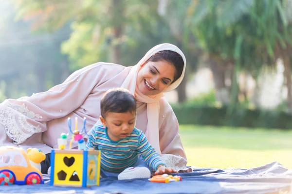 Arabic mom and her little toddler playing outdoors — Stock Photo, Image