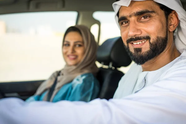 Arabic couple driving in a car — Stok fotoğraf