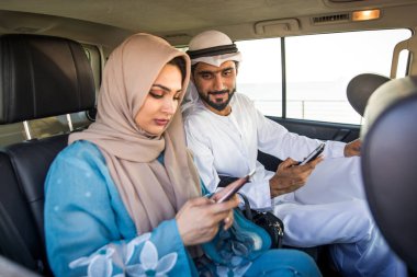 Arabic couple driving in a car
