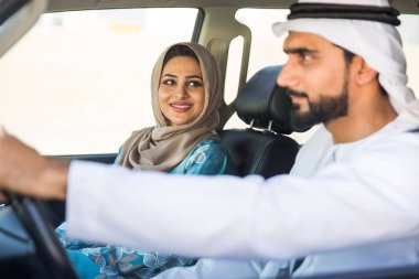 Arabic couple driving in a car
