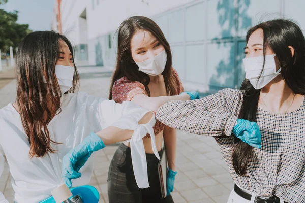 Group of asian girls going out after quarantine during coronavirus period. Young women outdoor with safety masks