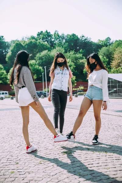 Group of asian girls going out after quarantine during coronavirus period. Young women outdoor with safety masks