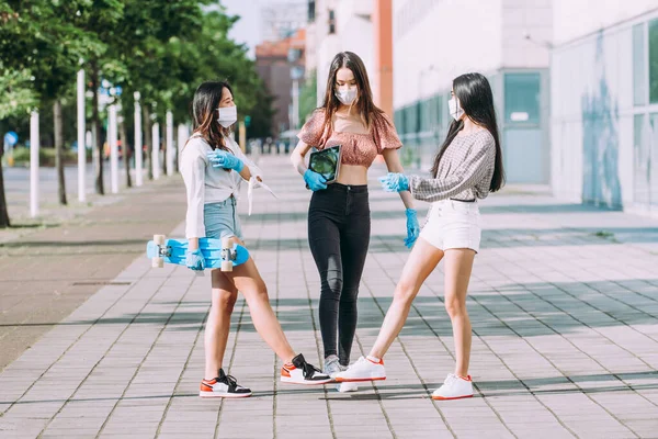 Group of asian girls going out after quarantine during coronavirus period. Young women outdoor with safety masks