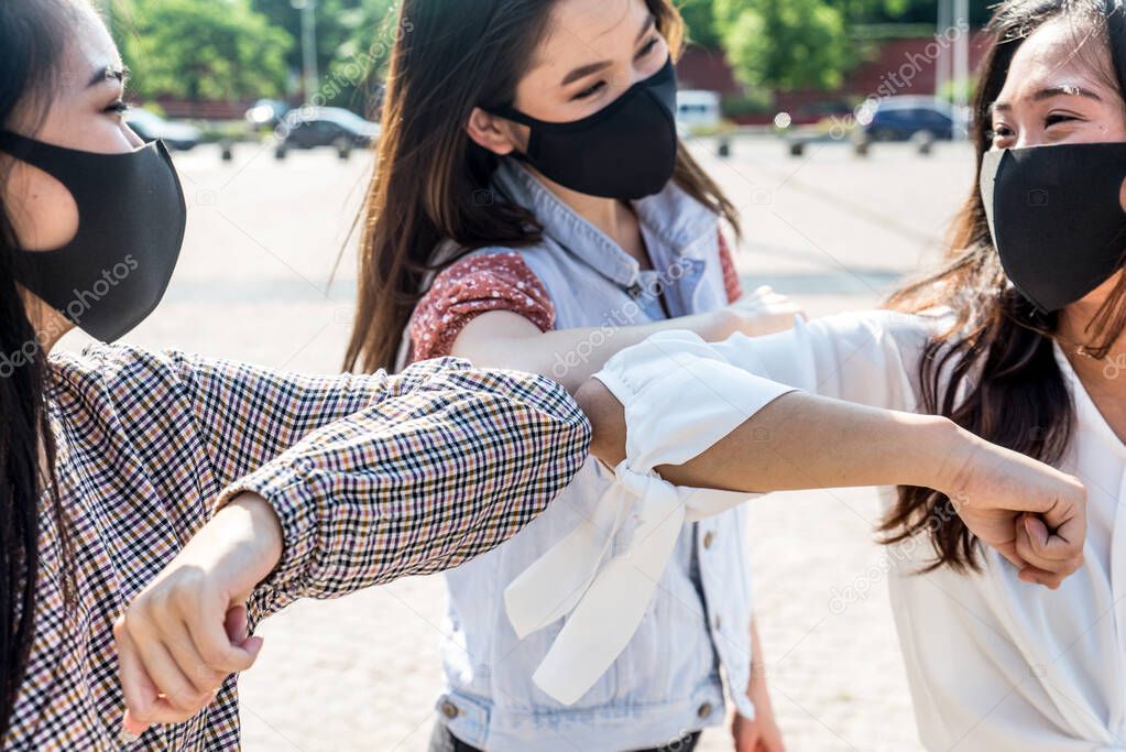 Group of asian girls going out after quarantine during coronavirus period. Young women outdoor with safety masks