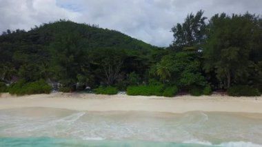 Seashore of Seychelles Indian Ocean, Lazare beach with view on mountain and island 4K footage