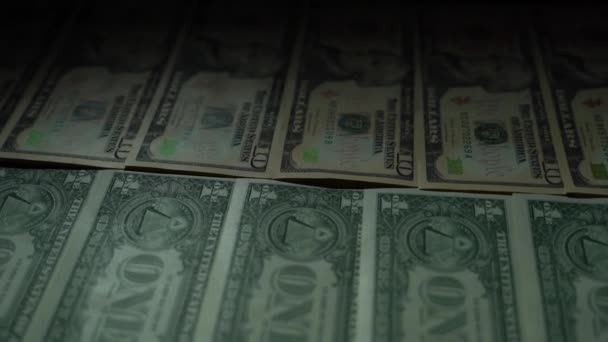 A lot of money of various denominations lie in a dark room on the table 4K — Stock Video