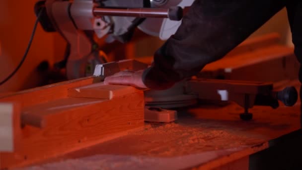 White man cuts a bar with a circular saw in the workshop — Stock Video