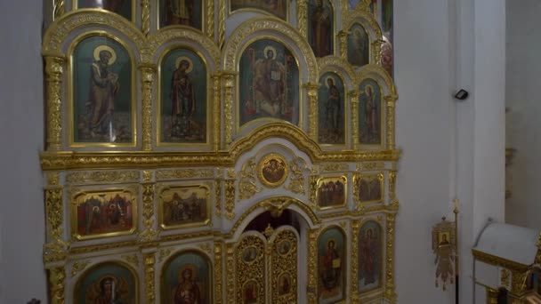 Many icons in chirch on the wall in easter holiday from camera crane in 4K — kuvapankkivideo