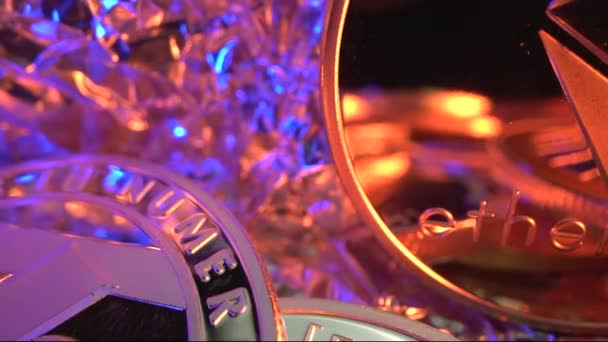 Macro shot of Etherium ETH gold crypto coin in surround of another coins with gold and blue background. Mining. Halving. Cyrrency of future — Stock Video