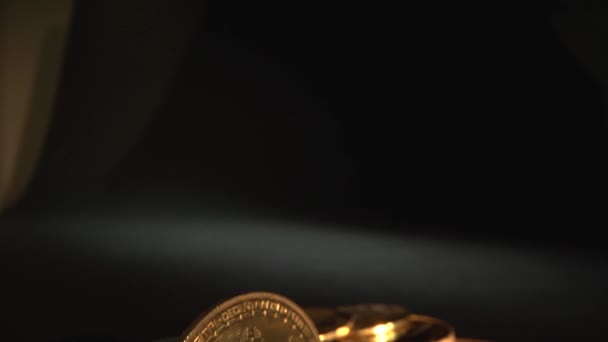 Bitcoin BTC ön planda. Kamera, siyah arkaplanlı altın kripto sikkeye kaydır. Makro atış. Yarı yarıya. Geleceğin parası. Sikke başka bir kripto sikkeyle çevrilidir.. — Stok video