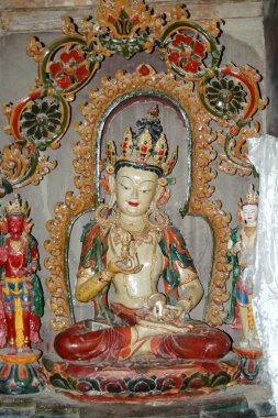 Beyaz bir Tibet tanrısının altın tacındaki antik heykeli.