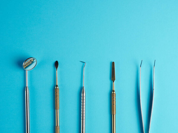 Professional dental tools on blue background