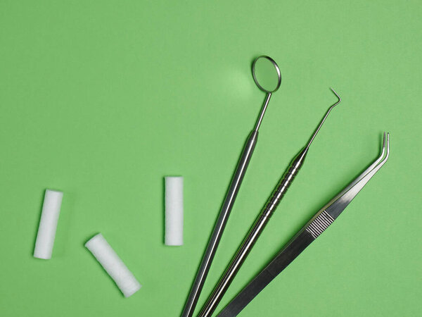 Professional dental tools on green background