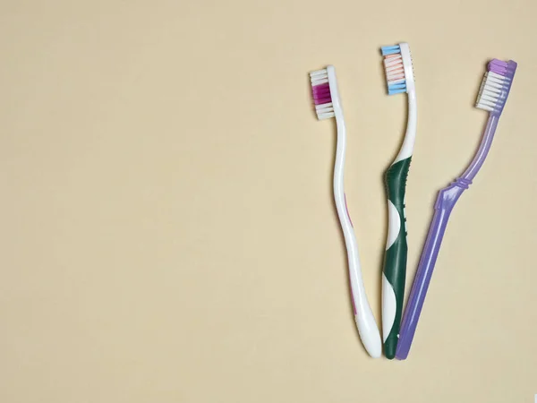 Toothbrushes on fawn background. Dental care concept