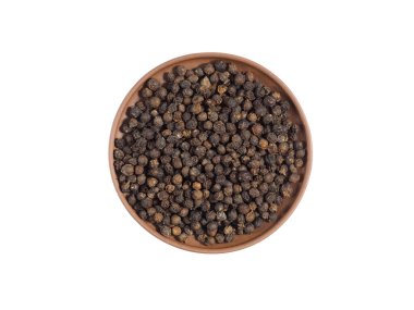 Kahverengi kil tabakta, beyaz üzerine izole edilmiş baharat karabiberi. Sağlıklı beslenme, ayurveda, naturopati konsepti