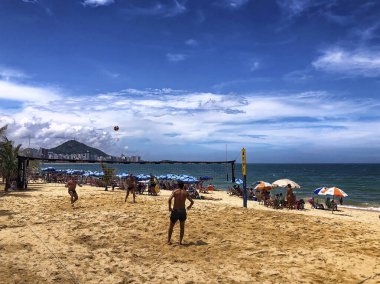 People playing volleyball on costa Beach, Vila Velha, State of Espirito Santo - Brazil. Day time shot clipart