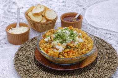 Sepet ve sosta beyaz ekmek dilimleri olan ev yapımı sebze güveci.