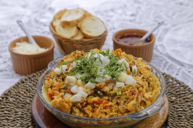 Sepette beyaz ekmek dilimleri ve soslarla taze pişmiş güveç.