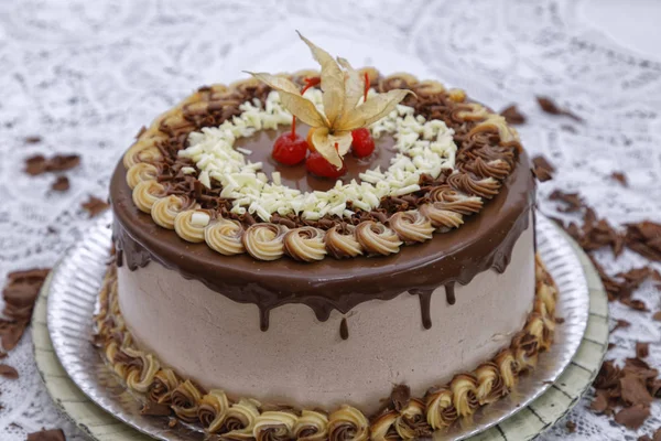 caramel cappuccino cake layer cake with mocha frosting decorated cherries and physalis