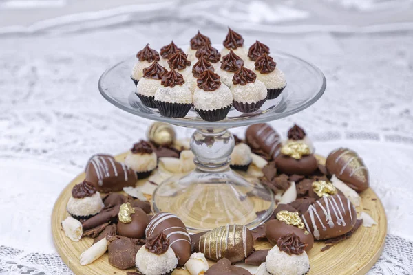 lots of tasty chocolate candies on kitchen table background