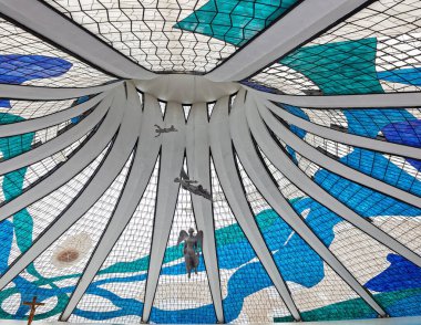 beautiful angel statues hanging from the ceiling with stained glass windows in Metropolitan Cathedral of Nossa Senhora Aparecida in Brasilia, Brazil