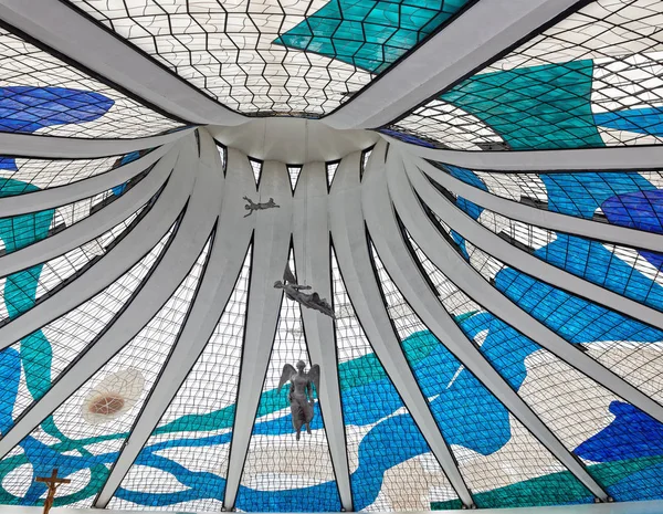 beautiful angel statues hanging from the ceiling with stained glass windows in Metropolitan Cathedral of Nossa Senhora Aparecida in Brasilia, Brazil