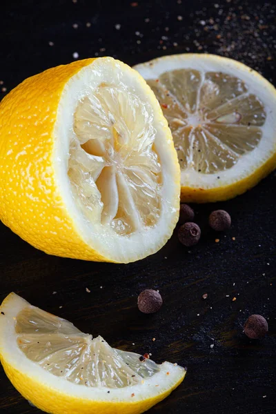 Metade espremida de limão, fatias e pimenta preta . — Fotografia de Stock