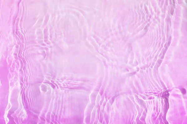 Streszczenie różowe tło fal i fal na wodzie — Zdjęcie stockowe