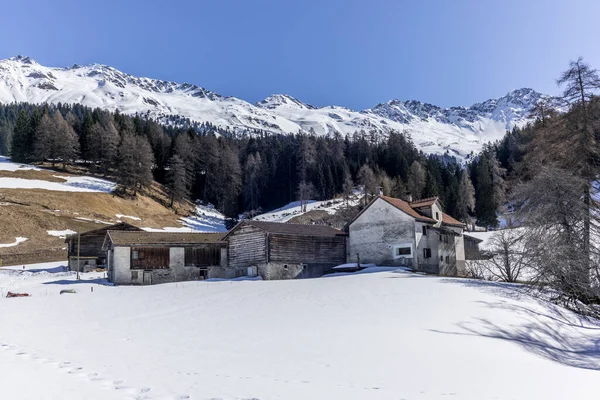 A lonely old farm on the empty and deserted ski slopes during the corona virus lockdown in the Swiss Alps